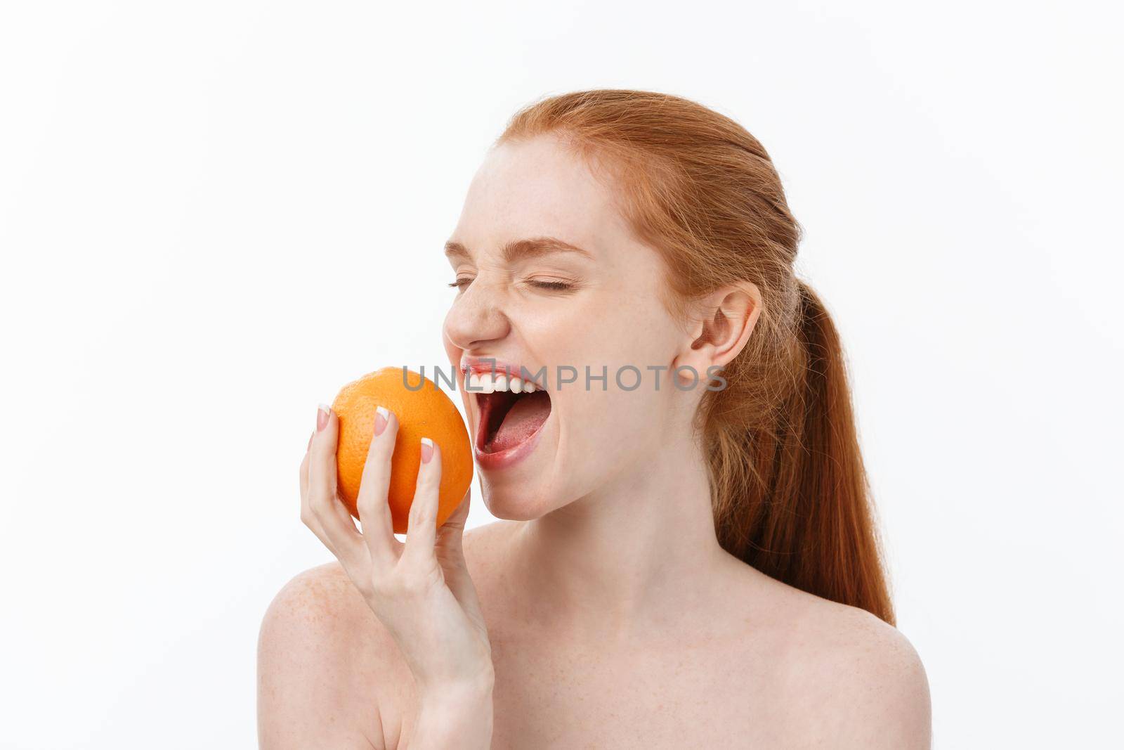 Portrait beautiful woman with a orange isolated