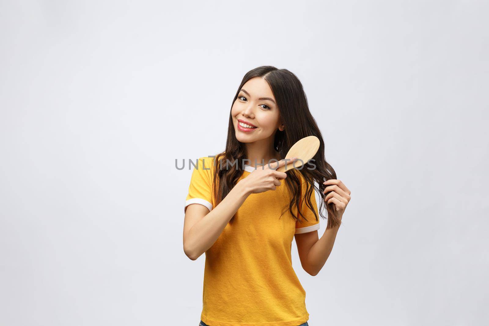 portrait of a beautiful young woman comb wonderful hair isolated on white background, asian beauty