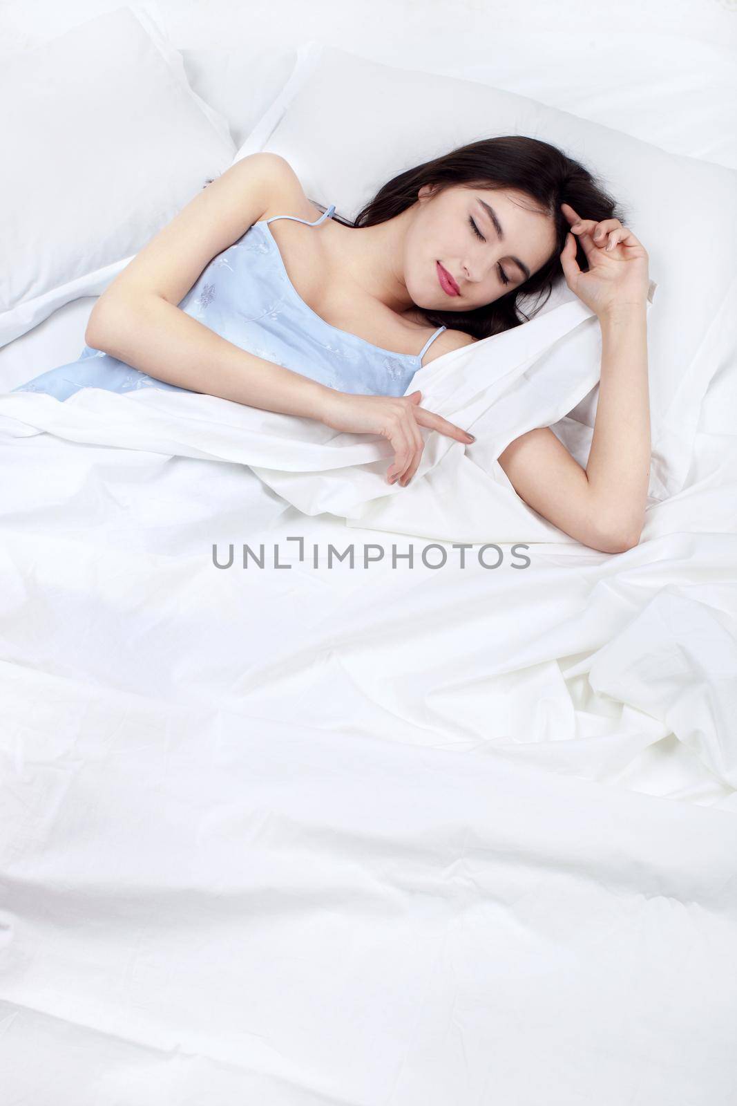 lonely woman in bed missing her partner overhead view of sleeping beauty
