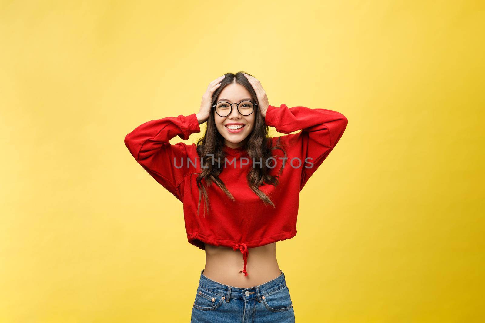 Portrait Happy Asian girl is surprised she is excited.Yellow background studio.