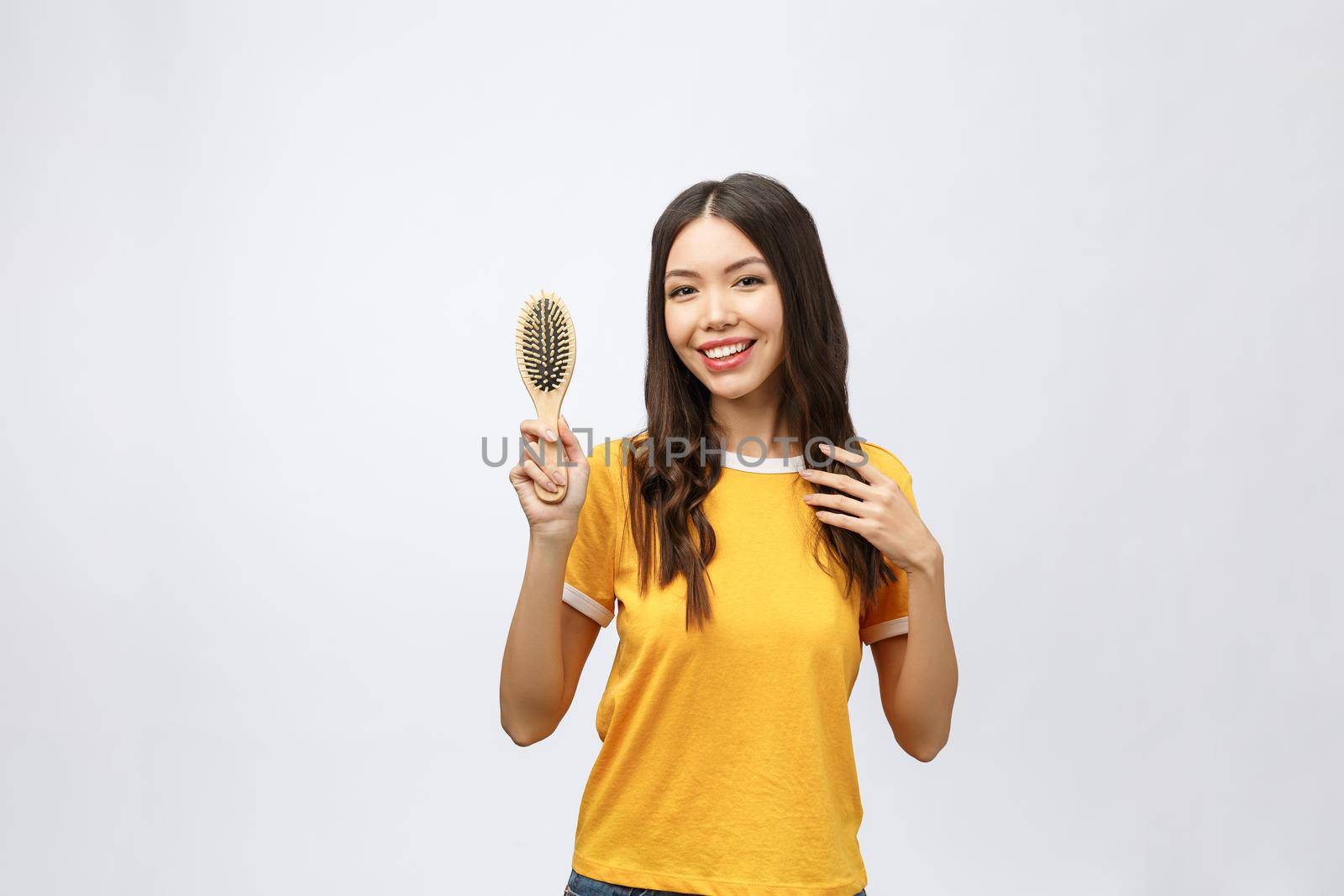 portrait of a beautiful young woman comb wonderful hair isolated on white background, asian beauty