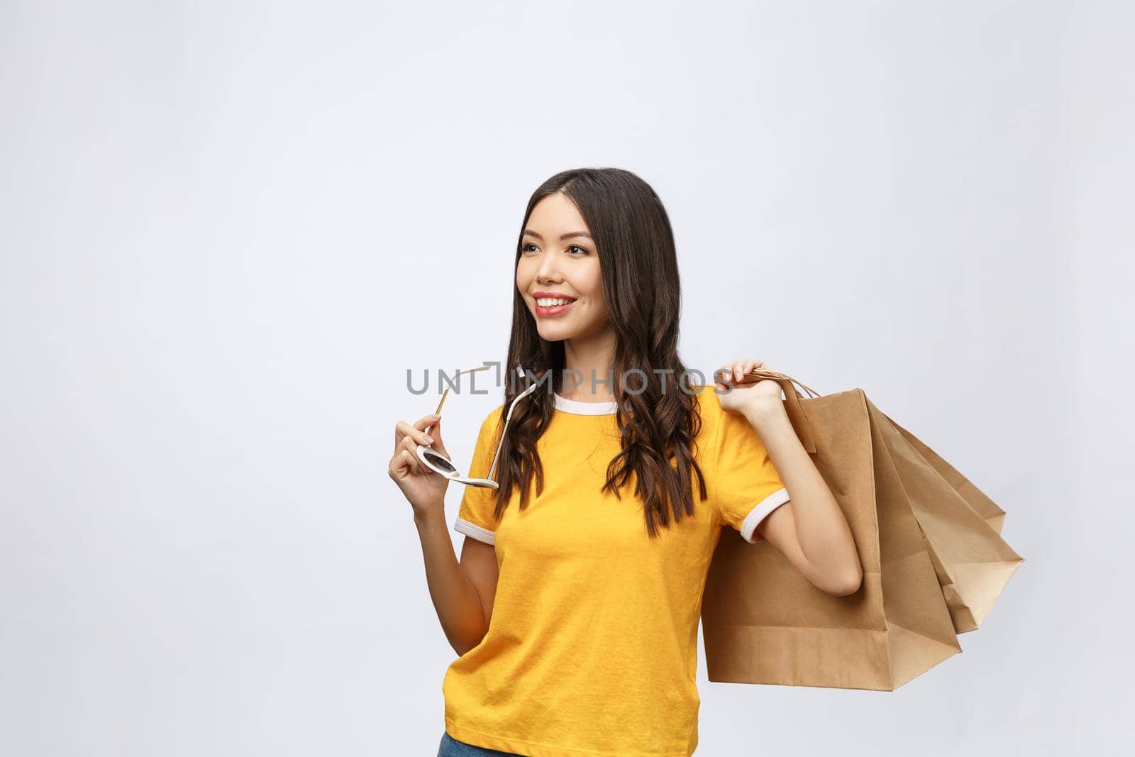 Beautiful Attractive Asian Woman smile and holding shopping bags feeling so happiness and enjoy with black Friday sale in Shopping mall,isolated on white background,Shopping Concept. by Benzoix