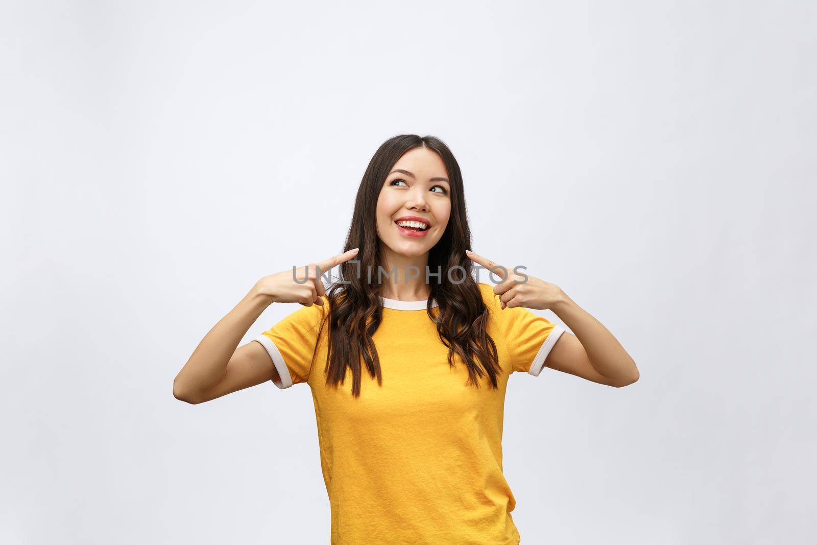 Portrait of happy young asian woman with finger point up.