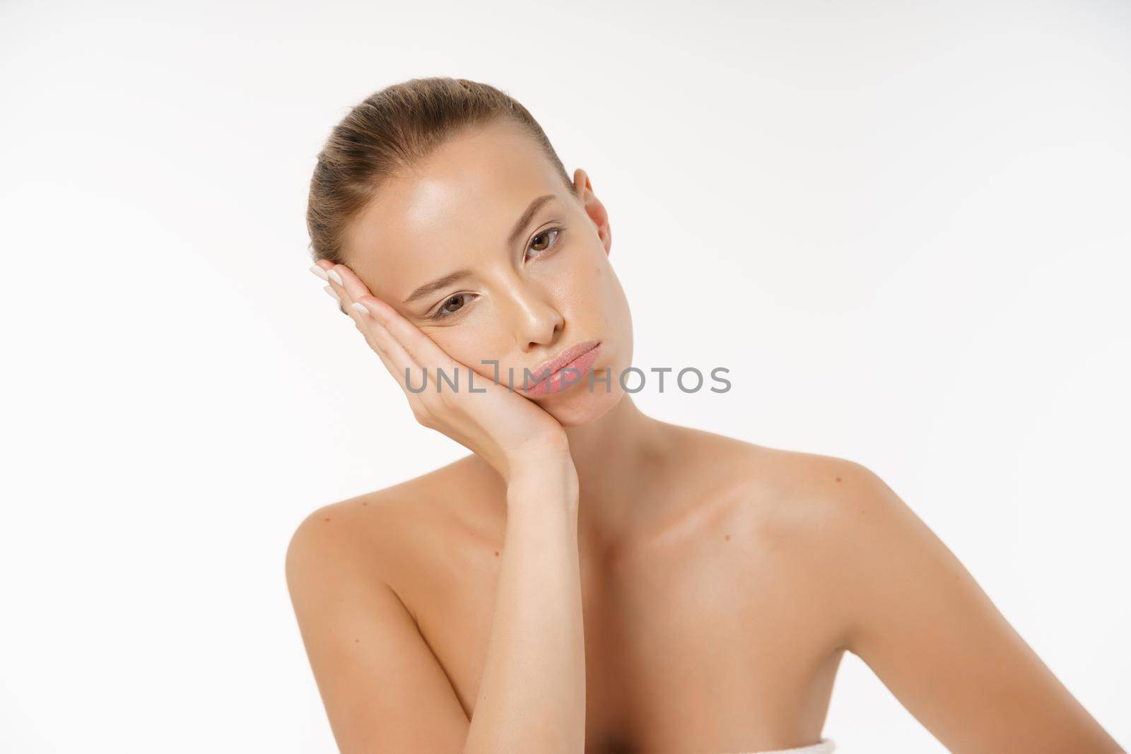 portrait of a young bored woman with no makeup , isolated over white background.