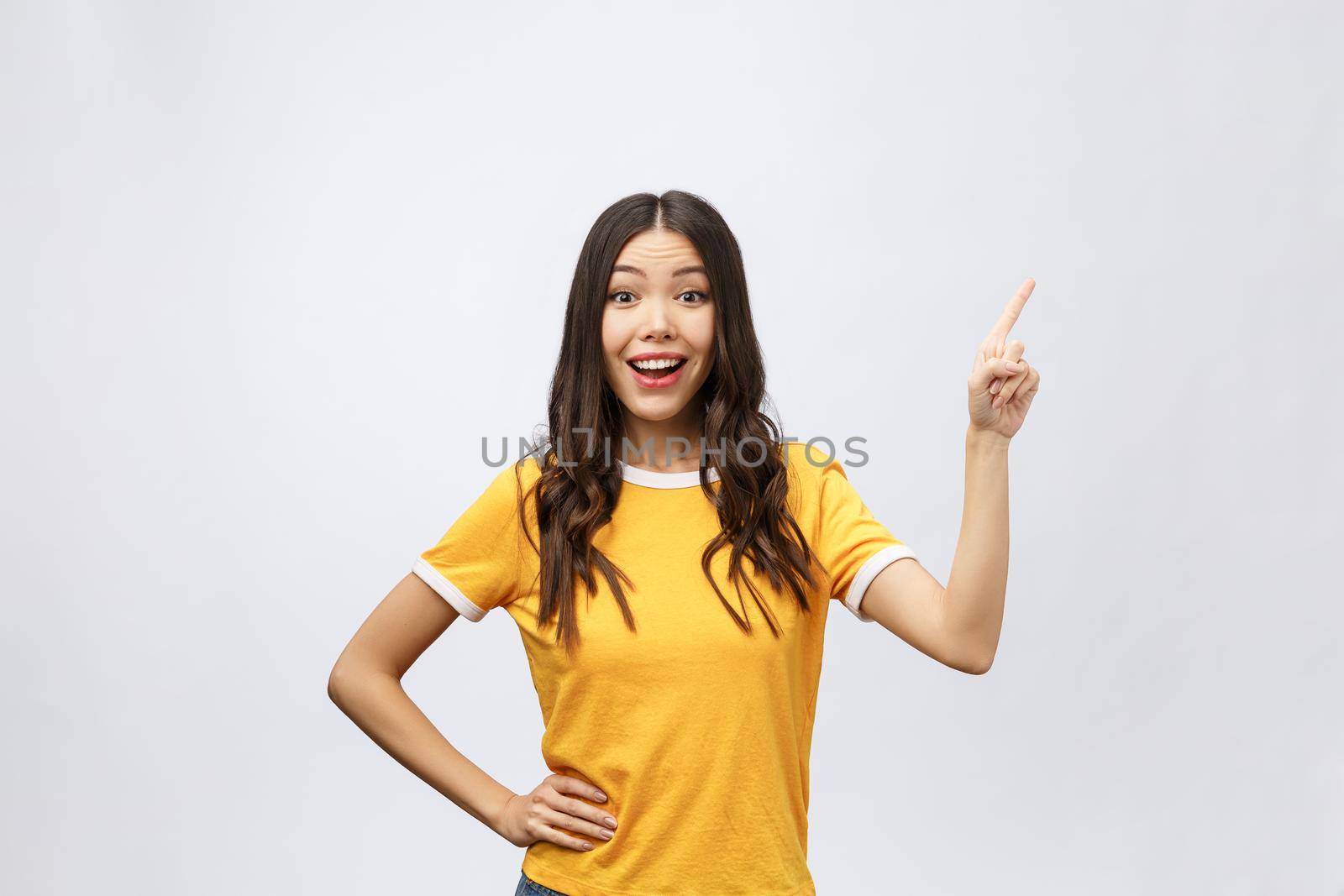 Portrait of happy young asian woman with finger point up by Benzoix