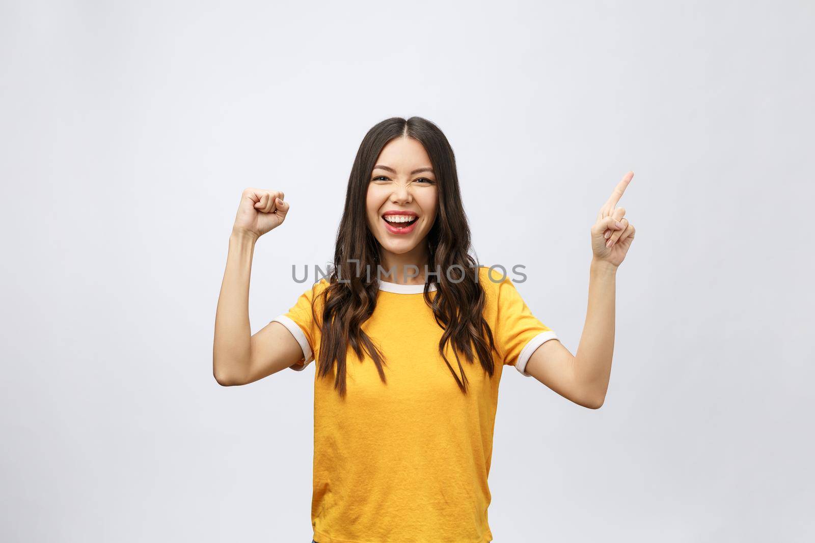 Portrait of happy young asian woman with finger point up by Benzoix
