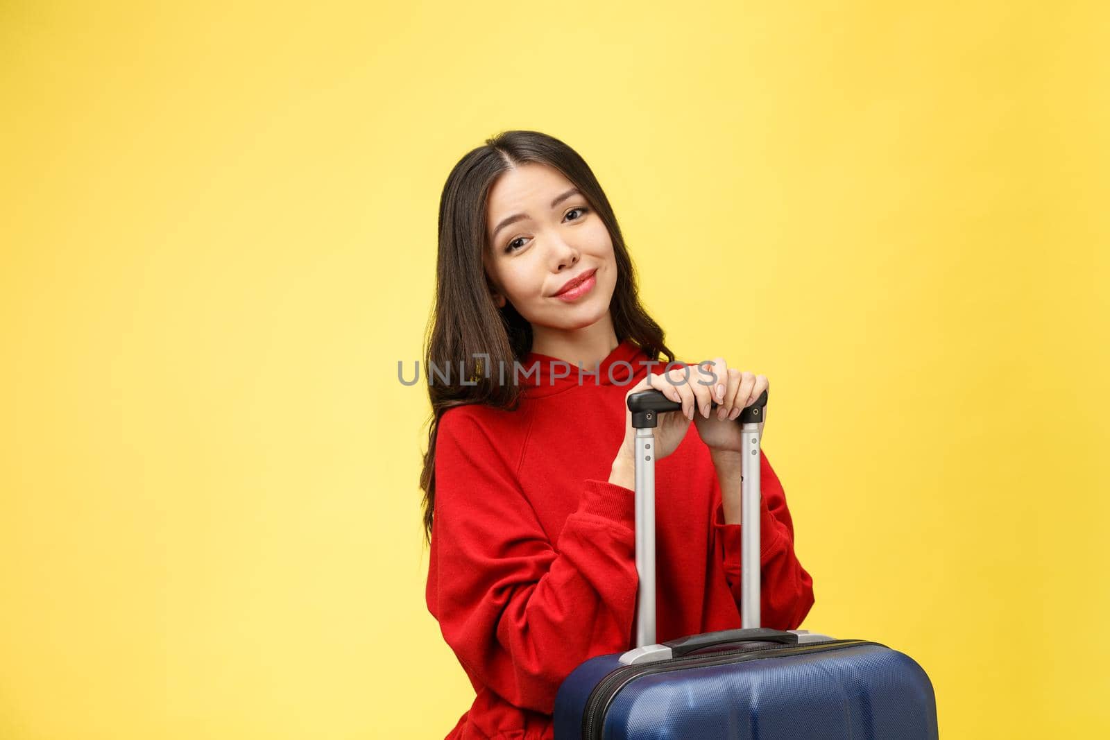 Dream about travel and vacation. Studio portrait of excited pretty young woman with praying hands. Isolated on yellow. by Benzoix