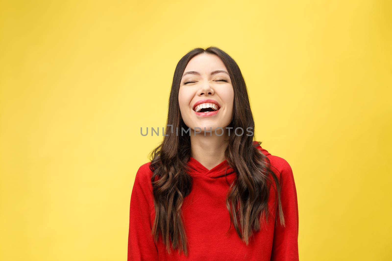 Happy cheerful young woman rejoicing at positive news or birthday gift, looking at camera with joyful and charming smile. student girl relaxing indoors after college.