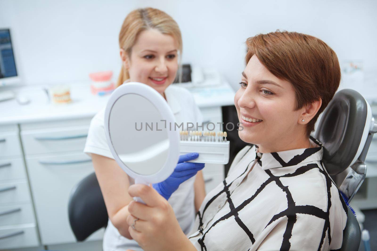 Woman getting dental treatment by MAD_Production