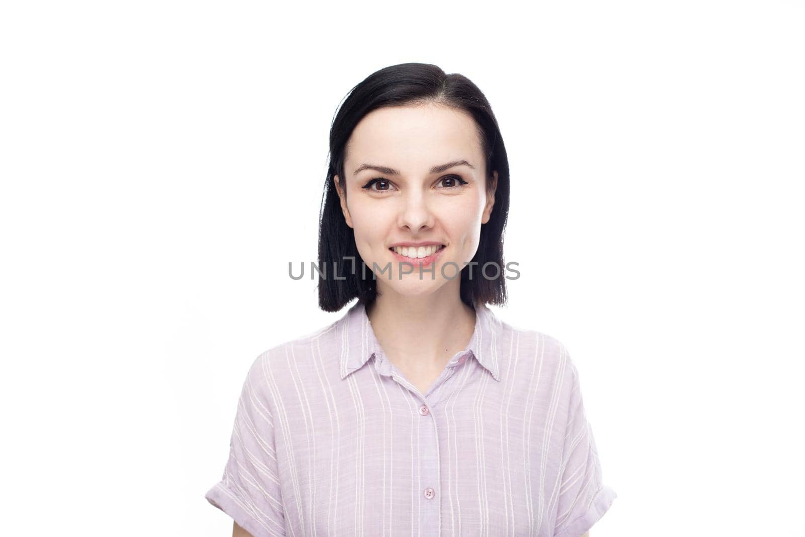 smiling brunette woman in lavender shirt, white background. High quality photo