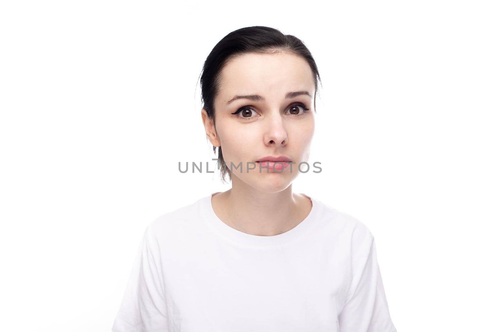 brunette woman in white t-shirt, white studio background by shilovskaya