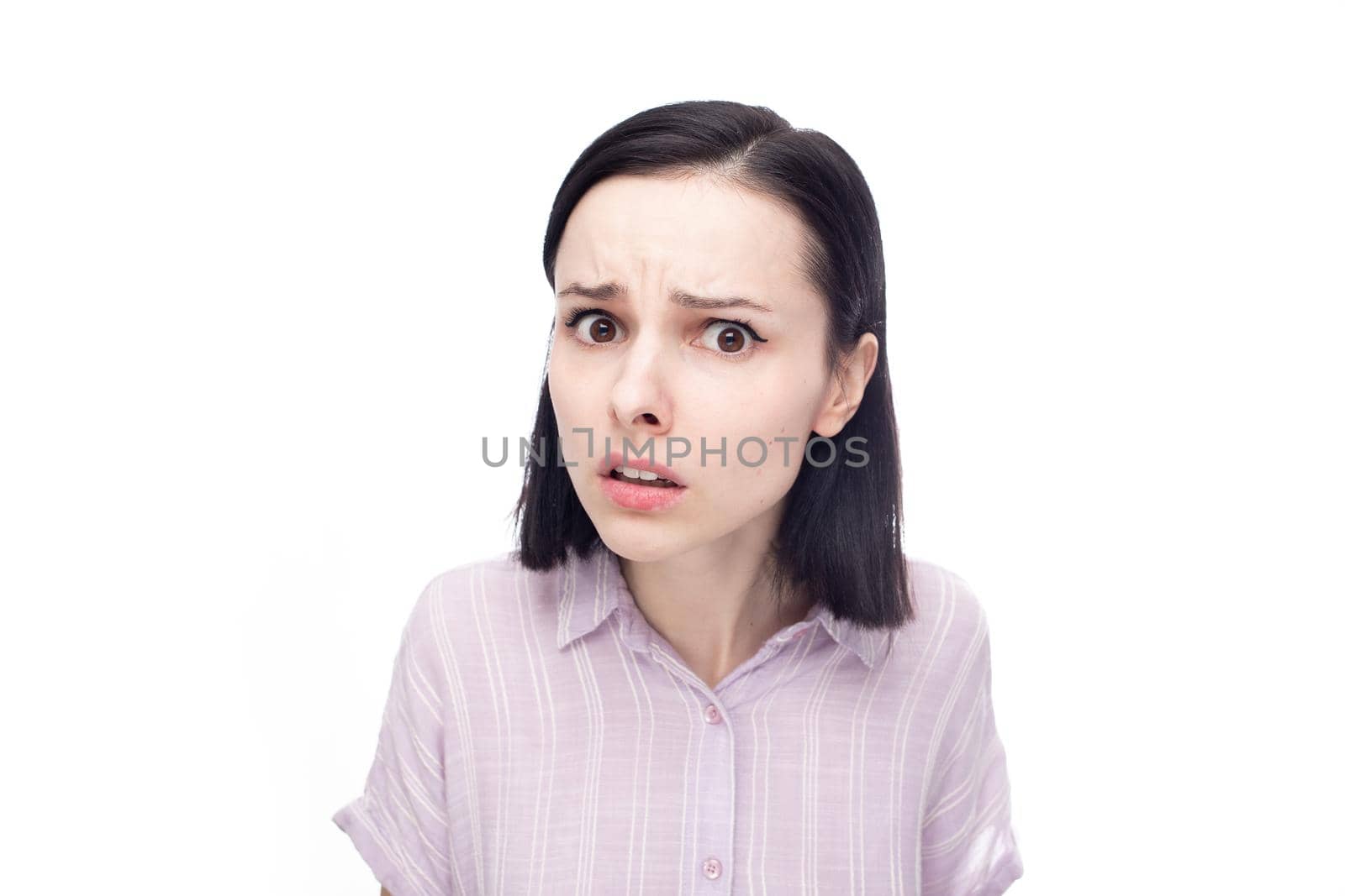 displeased shocked woman in purple shirt, white background. High quality photo