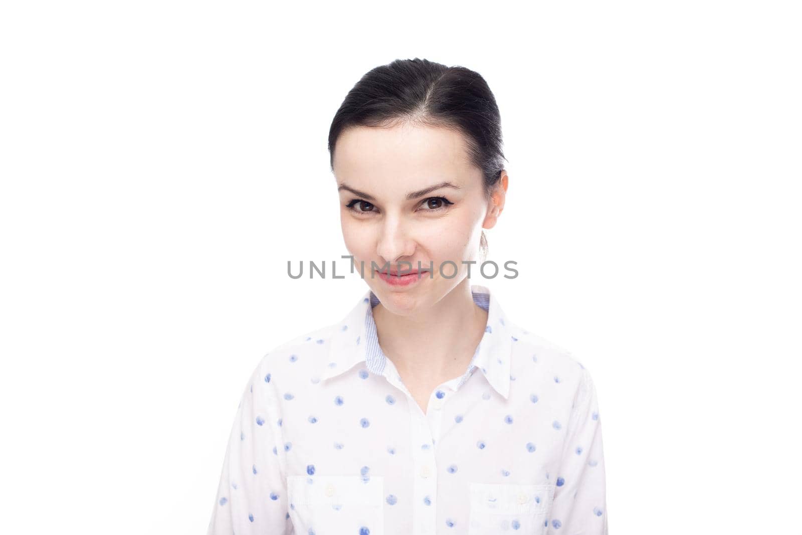 a woman in a white shirt with blue polka dots smiles mysteriously, white background by shilovskaya