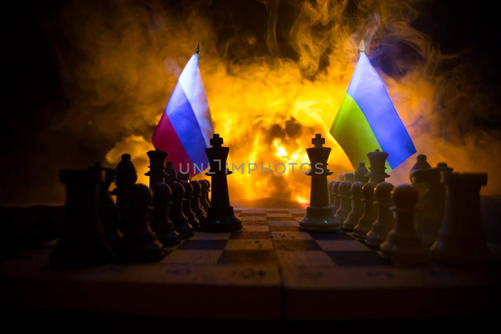 War between Russia and Ukraine, conceptual image of war using chess board, soldiers and national flags on the background of explosion. Ukrainian and Russian crisis. Selective focus