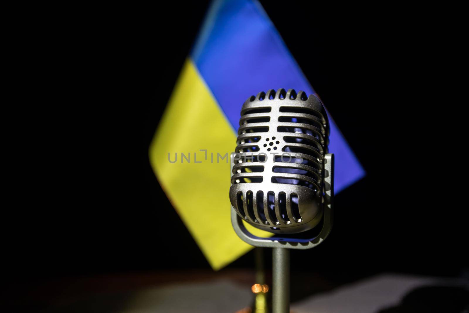 Microphone on a background of a blurry flag Ukraine close-up by Zeferli