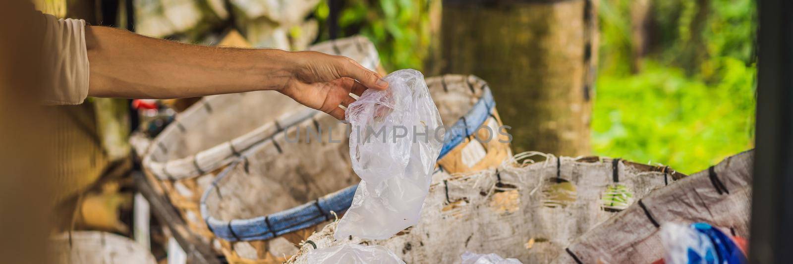 Man separately picks up trash. Separate garbage collection concept. BANNER, LONG FORMAT