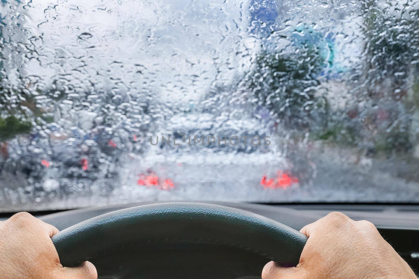 Raindrops on windshield from inside the car in traffic jam by toa55