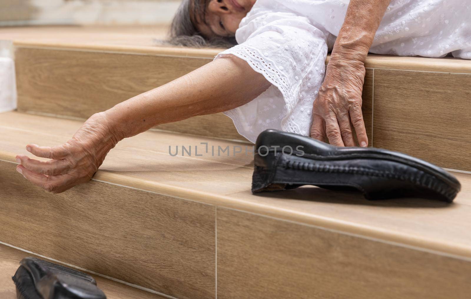 Elderly woman falling down on stair