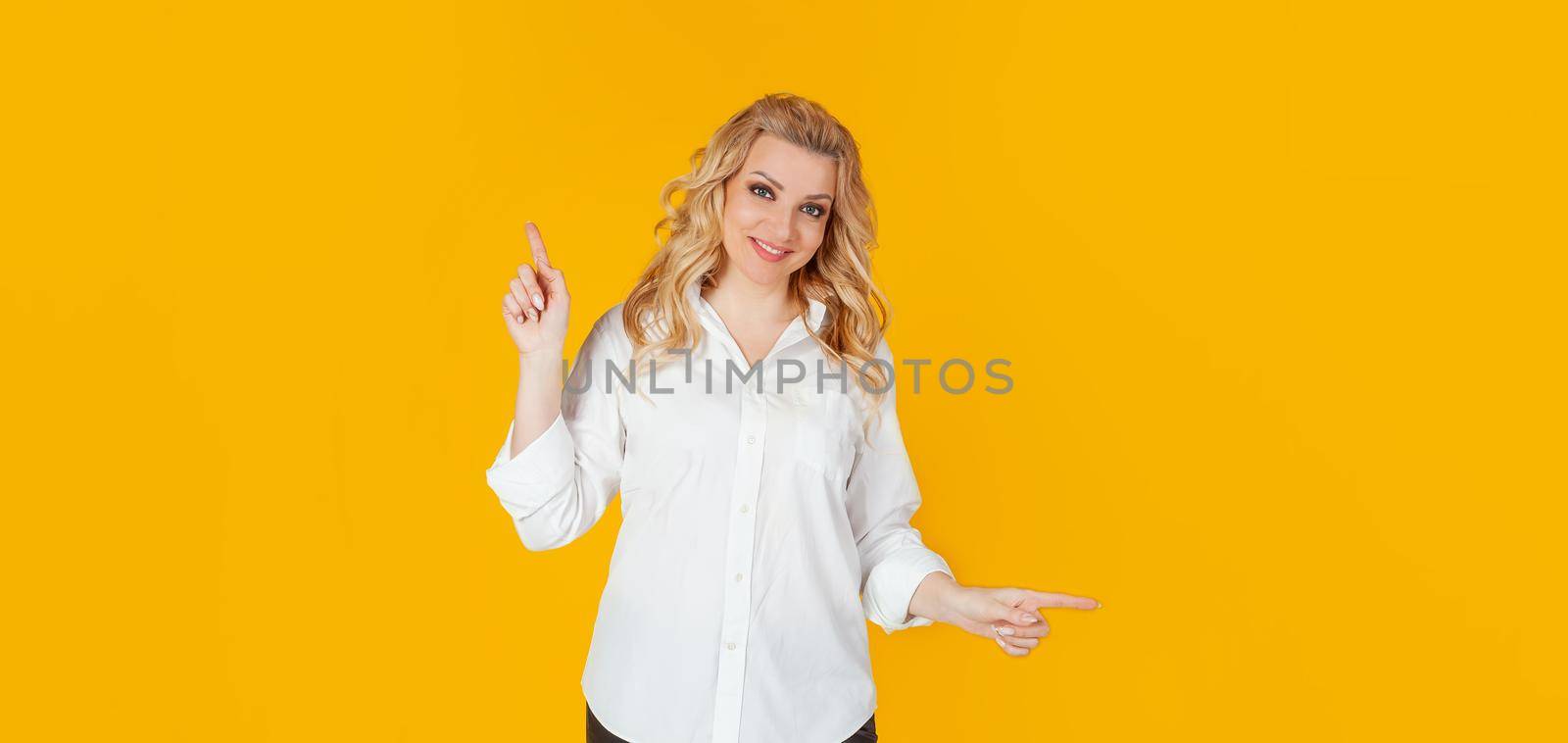 Pretty blonde woman smiles, gives advice, pointing sideways left and right, showing a good choice, promotes two products, both ways, standing on a white background