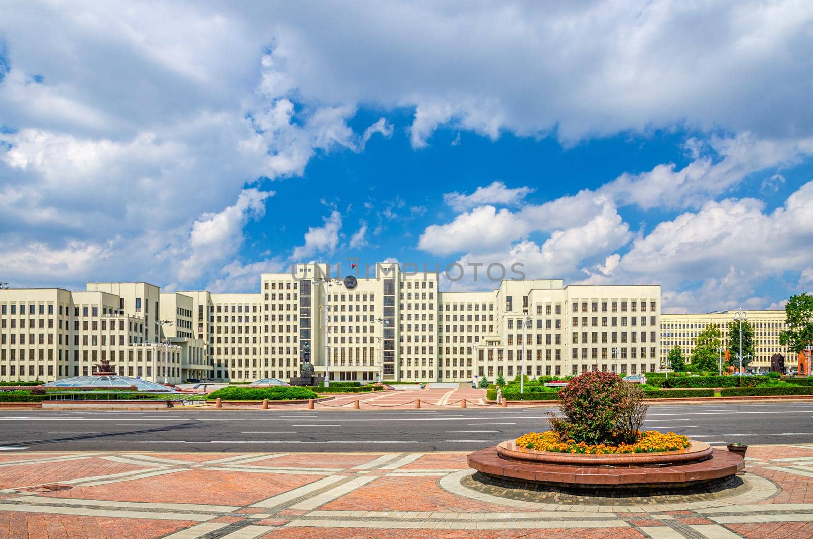 The Government House constructivism style building and Vladimir Lenin statue on Independence Square in Minsk city historical centre, blue sky white clouds in sunny summer day, Republic of Belarus