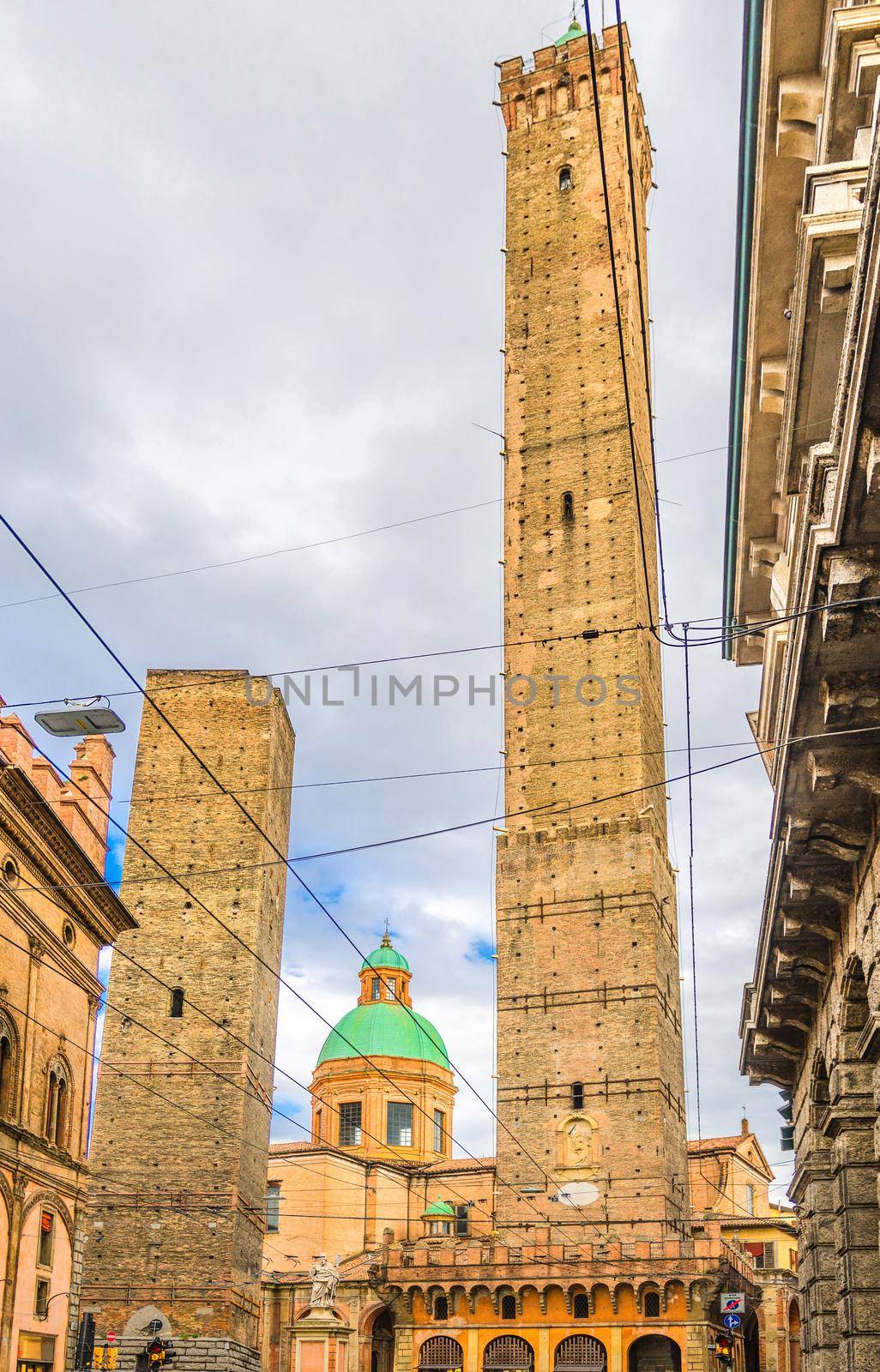 Two medieval towers of Bologna Le Due Torri: Asinelli and Garisenda and Chiesa di San Bartolomeo Gaetano church on Piazza di Porta Ravegnana square in old historical city centre, Emilia-Romagna, Italy