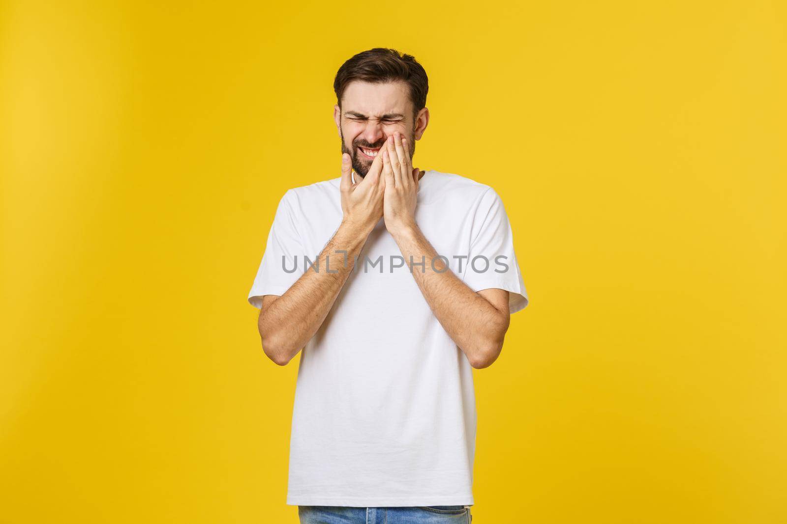 People, healthcare, dentistry and sickness concept. Depressed young unshaven man with painful stressed facial expression suffering from toothache