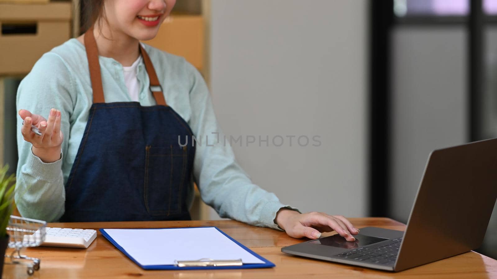 Startup small business owner using laptop computer for checking or accepting orders. Online selling. E-commerce. Online Shopping.