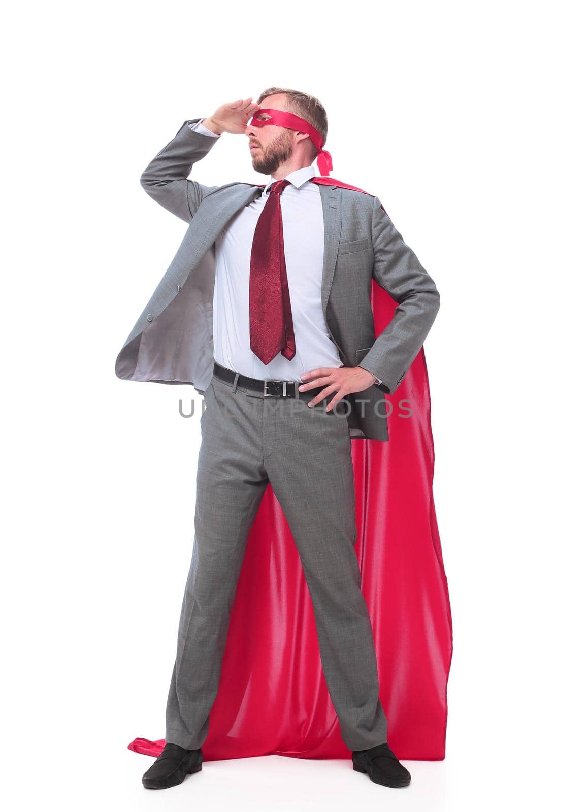 in full growth. superhero businessman staring intently into the distance. isolated on white