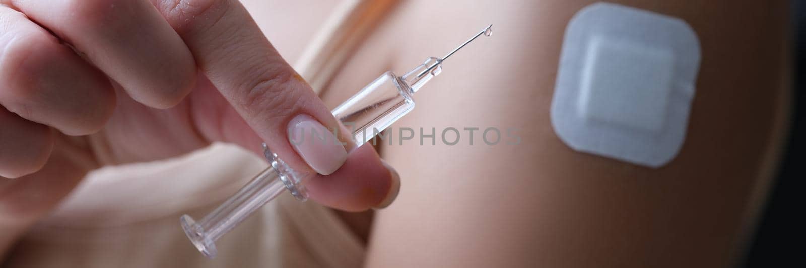 A woman makes an injection in her hand on her own, a plaster close-up. Pain medications intramuscularly, beauty injection