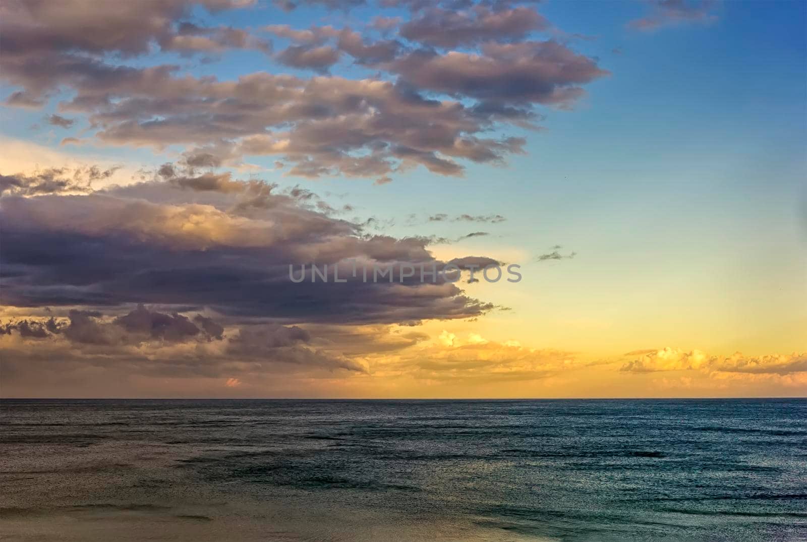 Beautiful colorful clouds over the sea. Amazing sky after sunset.