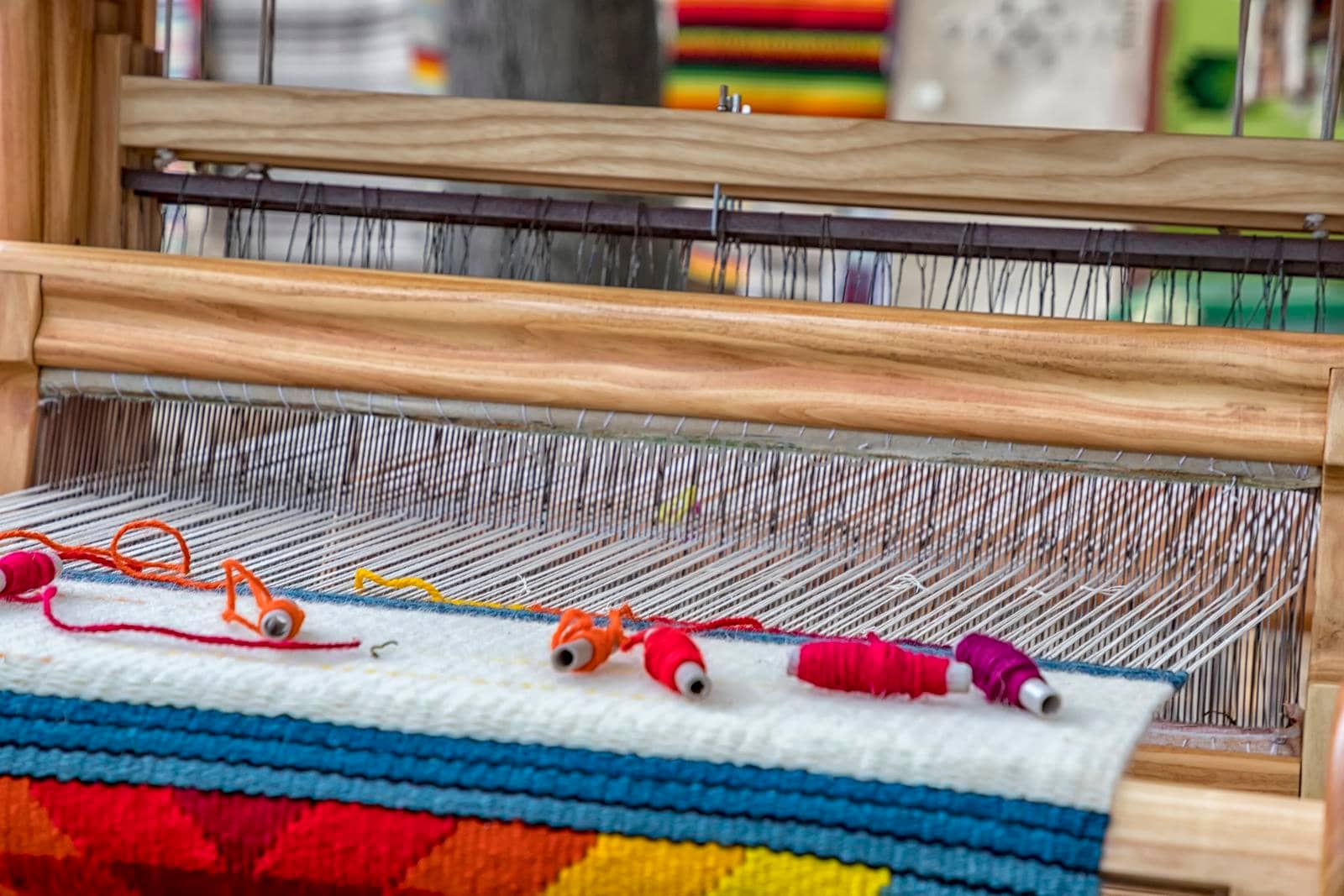 A traditional colorful vintage weaving loom and  thread of yarn.