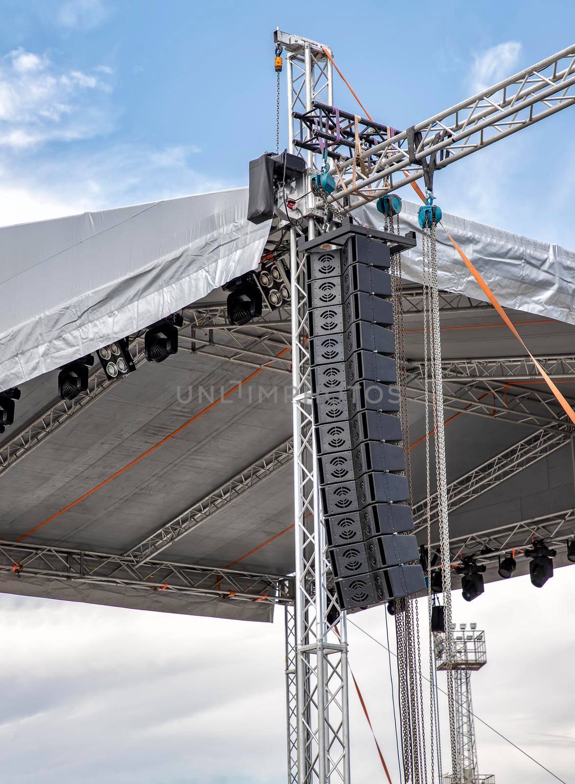 stage lighting and sound equipment on the outdoor stage before a concert by EdVal