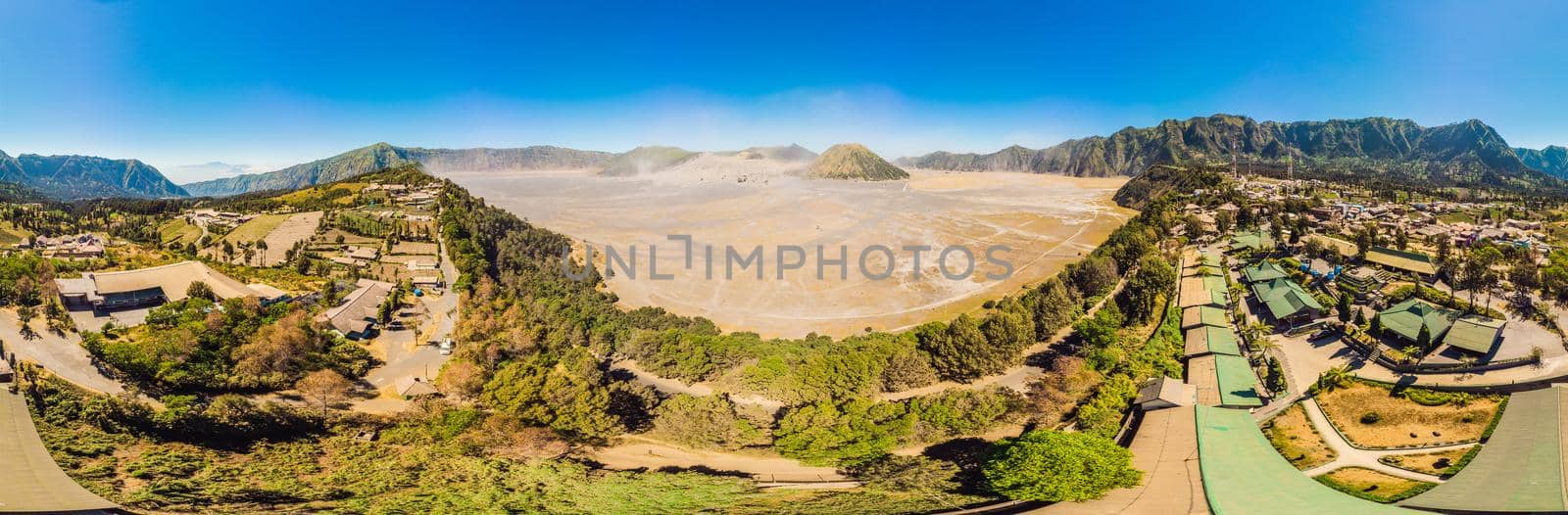 Panoramic Aerial shot of the Bromo volcano and Batok volcano at the Bromo Tengger Semeru National Park on Java Island, Indonesia. One of the most famous volcanic objects in the world. Travel to Indonesia concept.