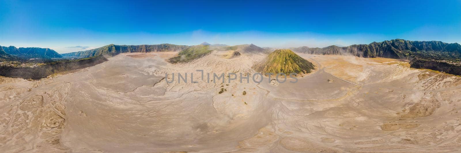 Panoramic Aerial shot of the Bromo volcano and Batok volcano at the Bromo Tengger Semeru National Park on Java Island, Indonesia. One of the most famous volcanic objects in the world. Travel to Indonesia concept.