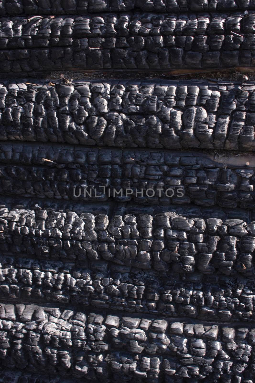 Natural fire ashes with dark grey black coals texture. It is a flammable black hard rock. copyspace by kajasja