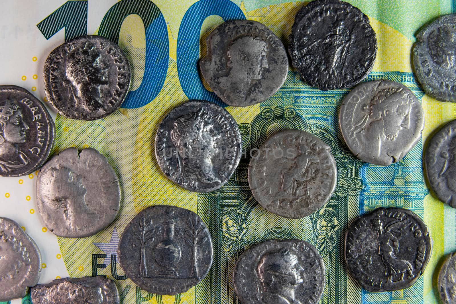 old roman coins on modern stoev banknote closeup