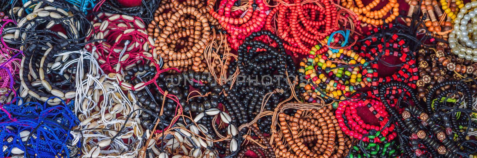 Typical souvenir shop selling souvenirs and handicrafts of Bali at the famous Ubud Market, Indonesia. Balinese market. Souvenirs of wood and crafts of local residents BANNER, LONG FORMAT by galitskaya