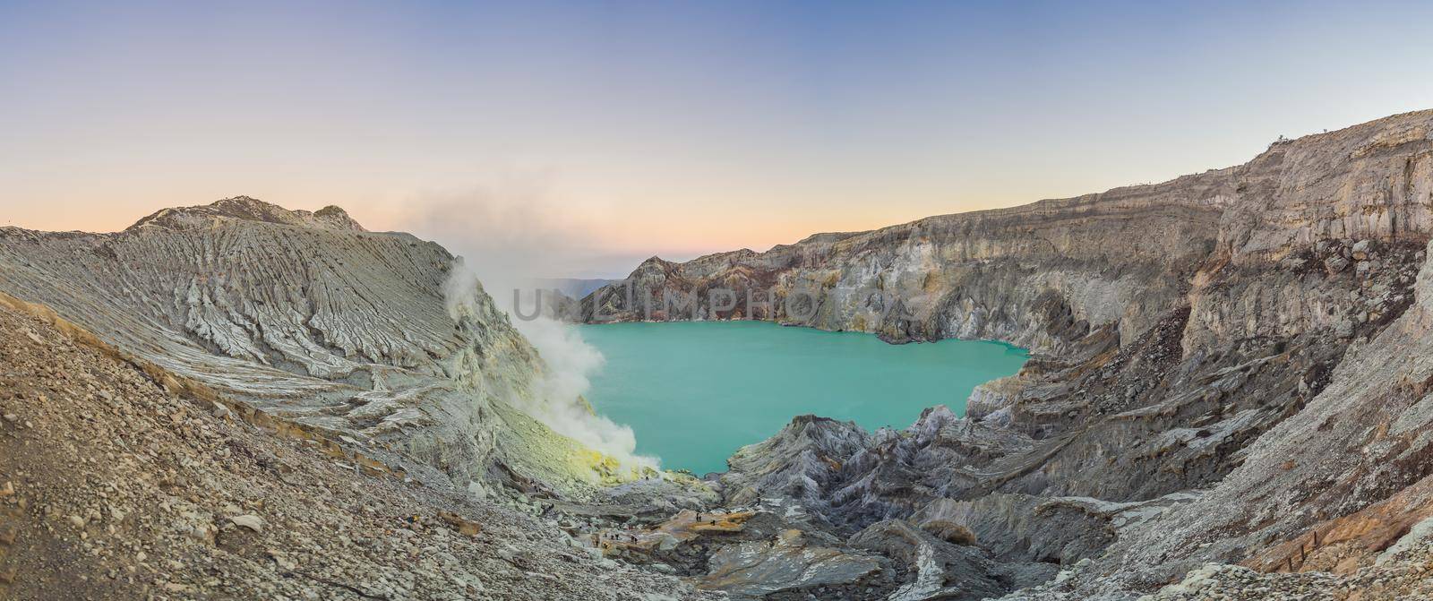 Panoramic shot of the Ijen volcano or Kawah Ijen on the Indonesian language. Famous volcano containing the biggest in the world acid lake and sulfur mining spot at the place where volcanic gasses come from the volcano.