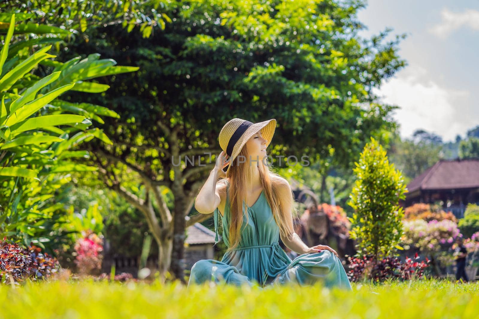 Young woman tourist in Taman Tirtagangga, Water palace, Water park, Bali Indonesia.