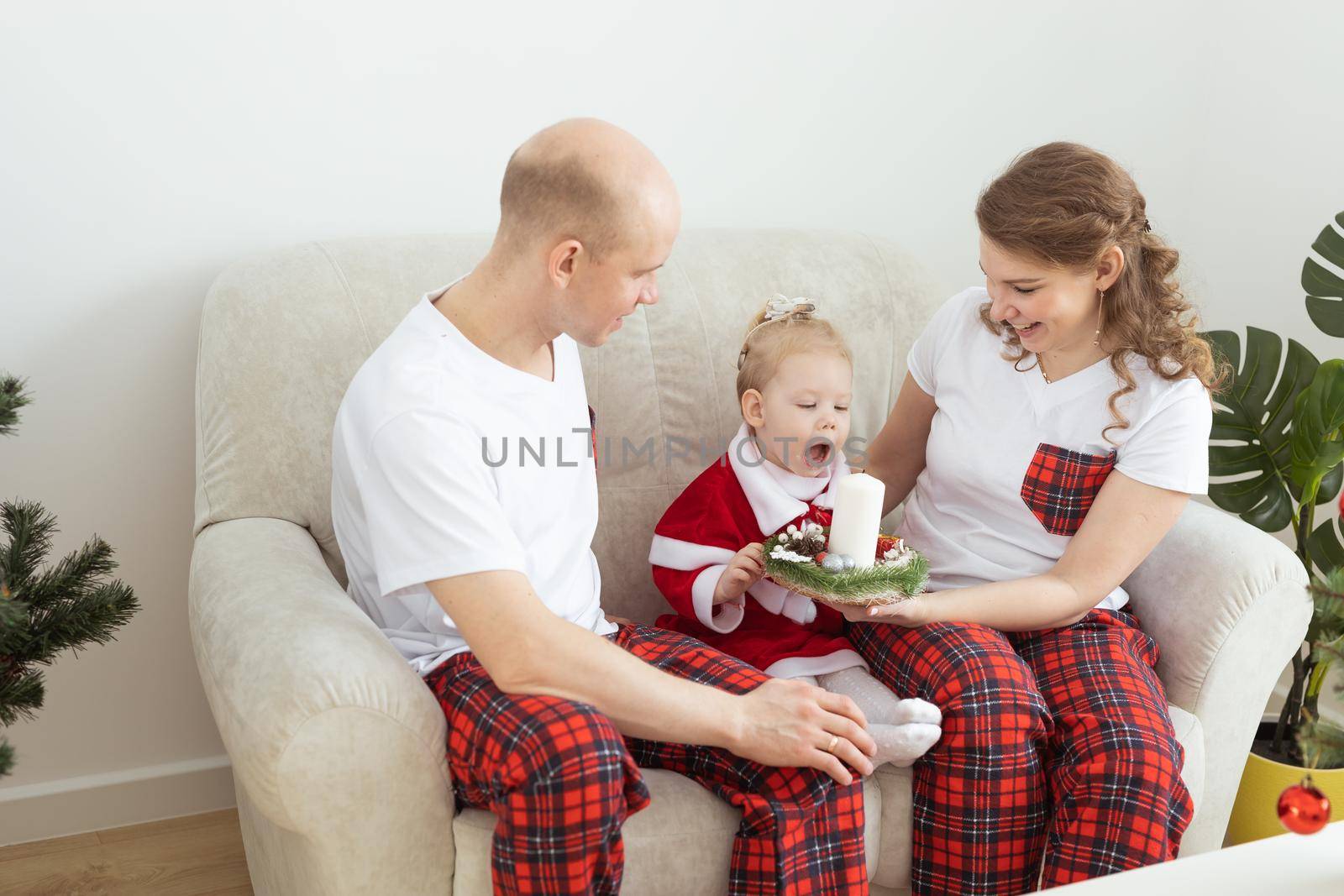 Child girl dressed in christmas dress with cochlear implants having fun at home - diversity and hearing aid and innovating technologies for treatment of deafness. Copy space and place for advertising by Satura86