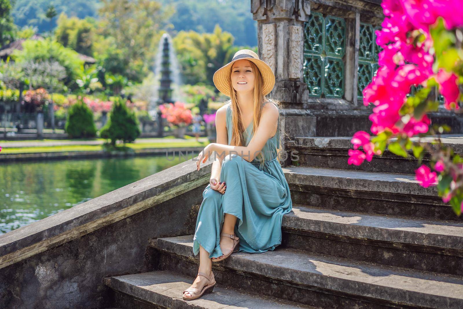 Young woman tourist in Taman Tirtagangga, Water palace, Water park, Bali Indonesia.