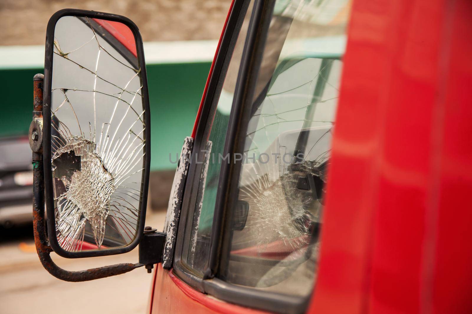 Cracked side mirror on an old truck. Broken truck mirror