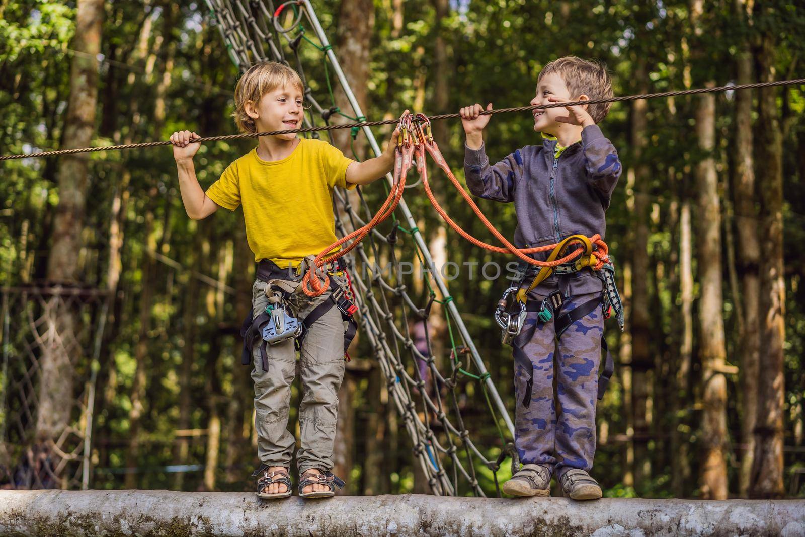 Two little boys in a rope park. Active physical recreation of the child in the fresh air in the park. Training for children.