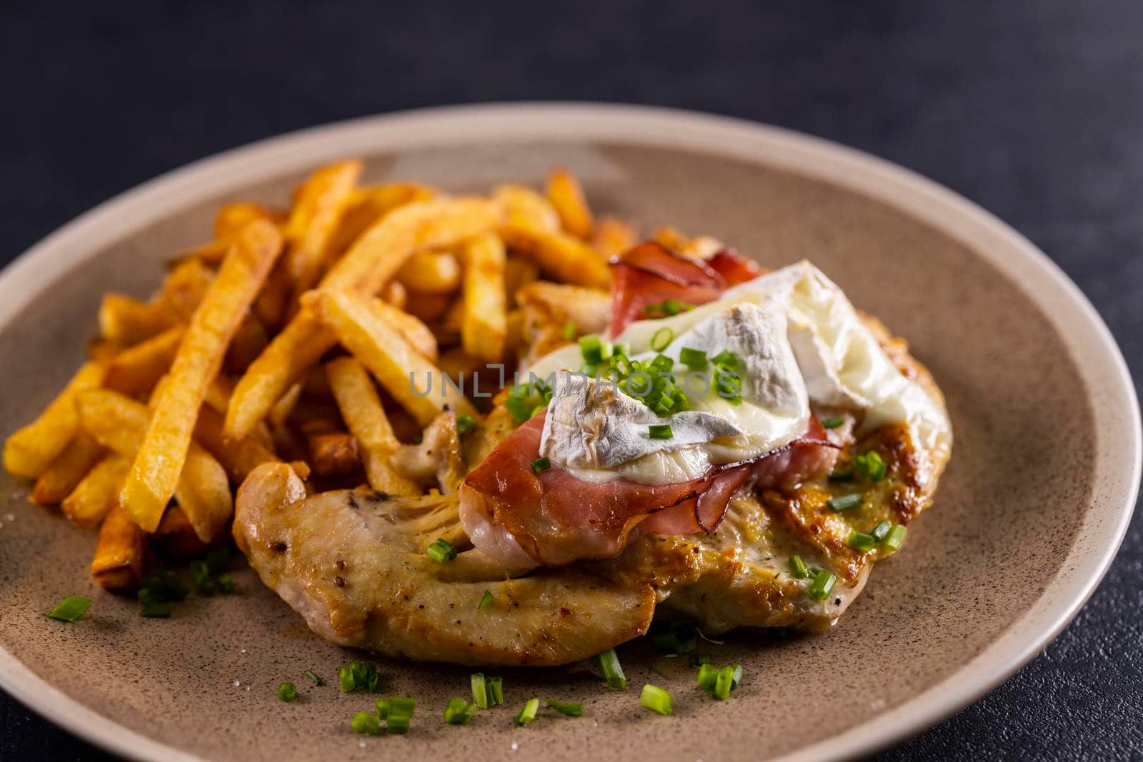 typical czech cuisine chicken slice baked with ham and camembert with french fries by phbcz