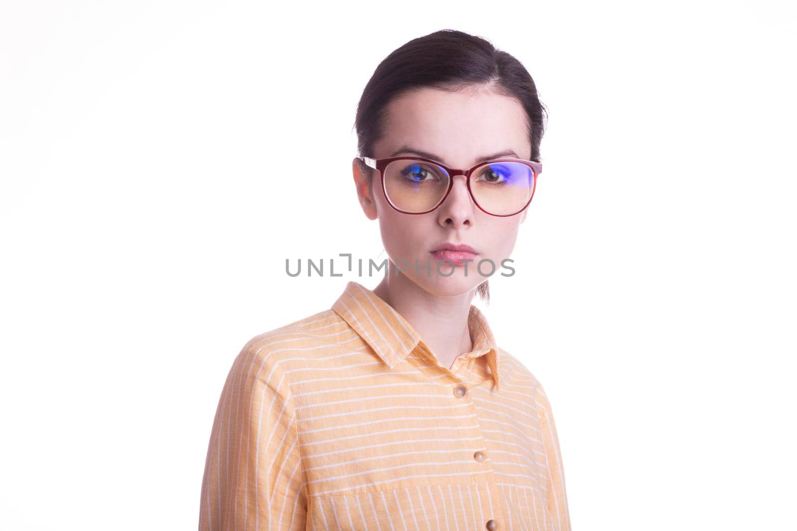 beautiful emotional woman in a yellow shirt and glasses for vision on a white background. High quality photo