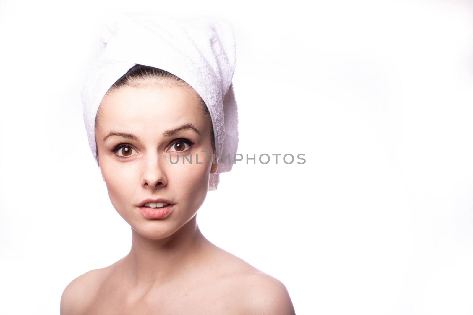 girl with a white towel on her head, white background. High quality photo
