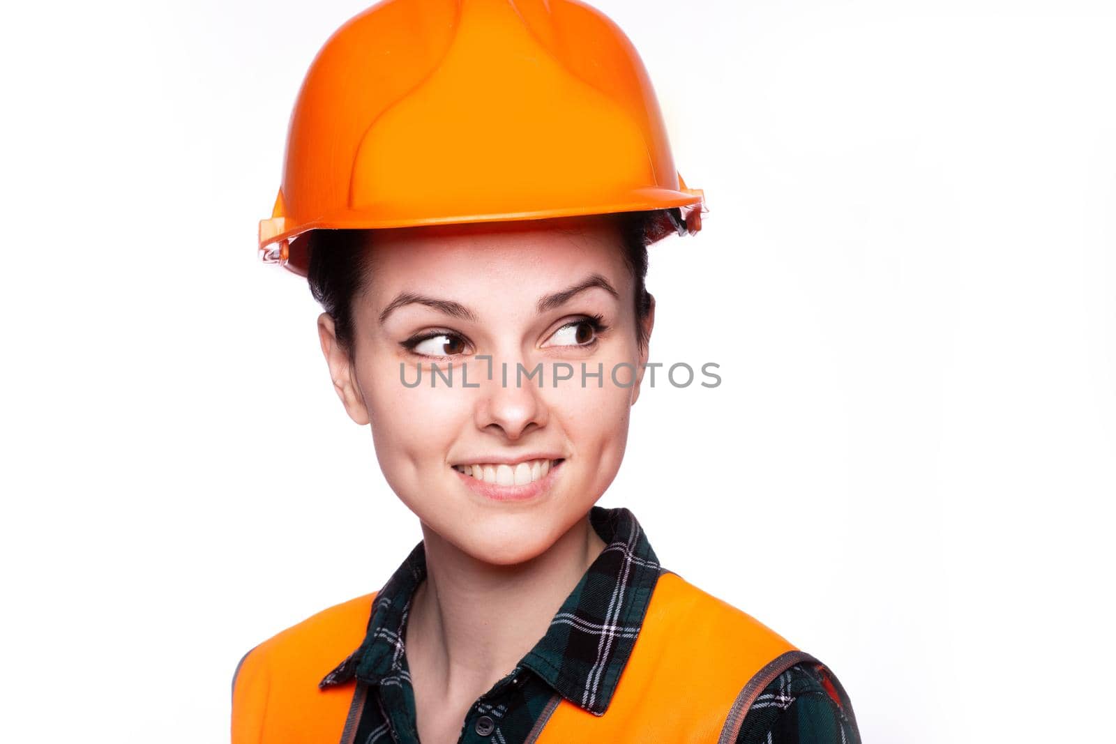 woman in construction safety helmet and orange vest, close-up portrait. High quality photo