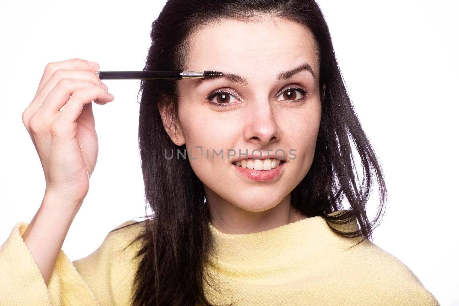 attractive young woman doing makeup by shilovskaya