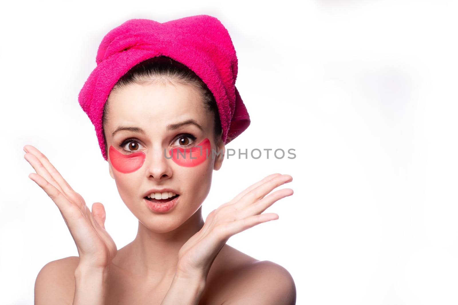 young woman after a shower in a pink towel and patches. High quality photo