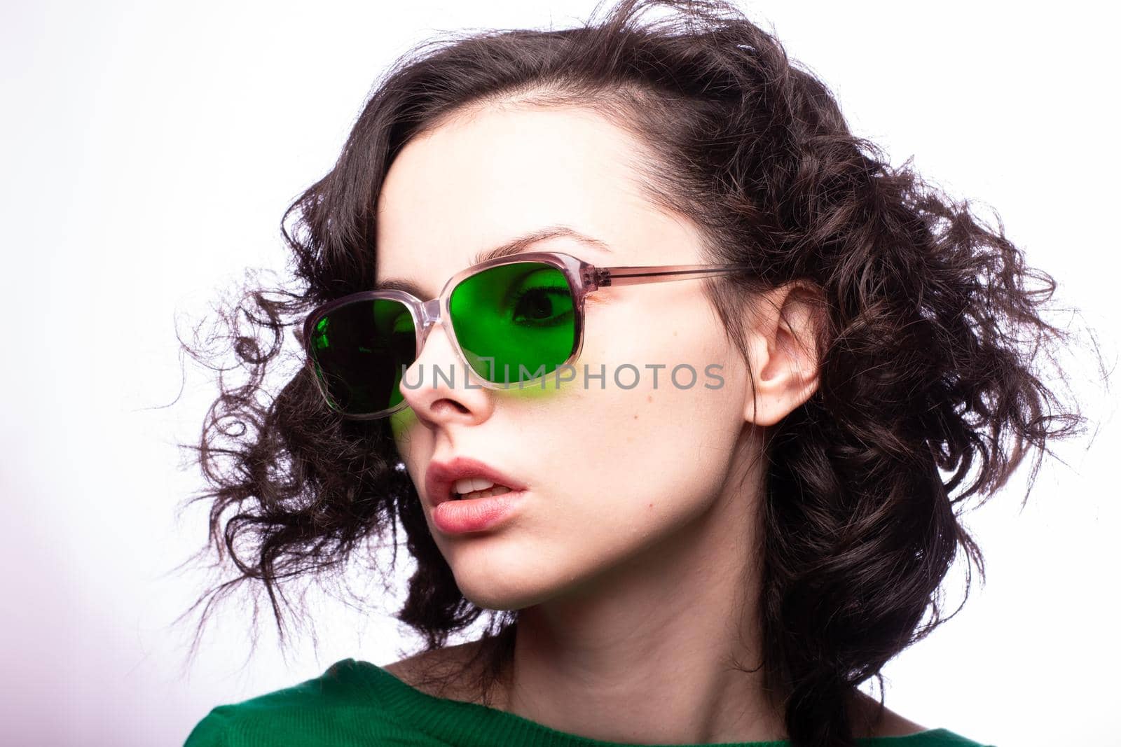 curly brunette woman in green glasses and green cardigan by shilovskaya